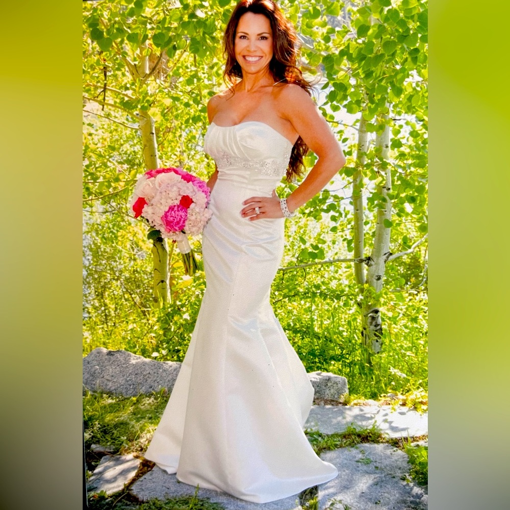 One of kind wedding dress size 2. I’m 5’2” 112 lbs.